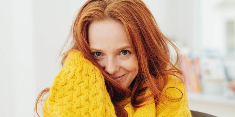 smiling woman looking happy in a sweater