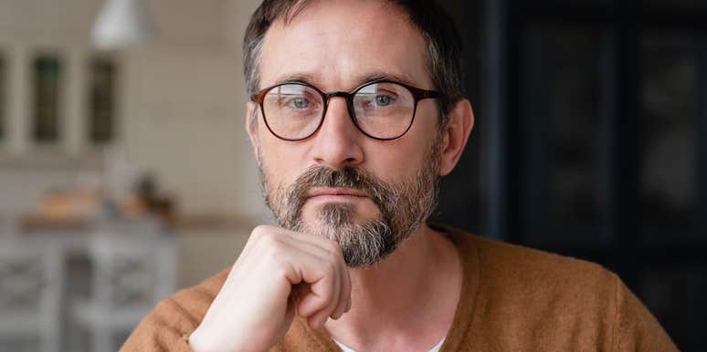 serious man wearing glasses looking at camera