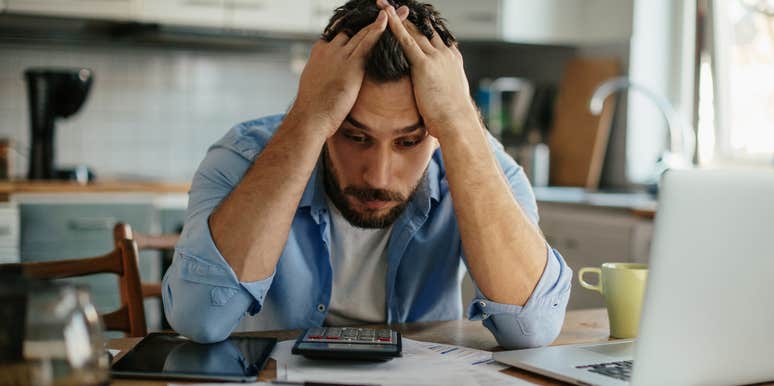 man stressed living paycheck to paycheck