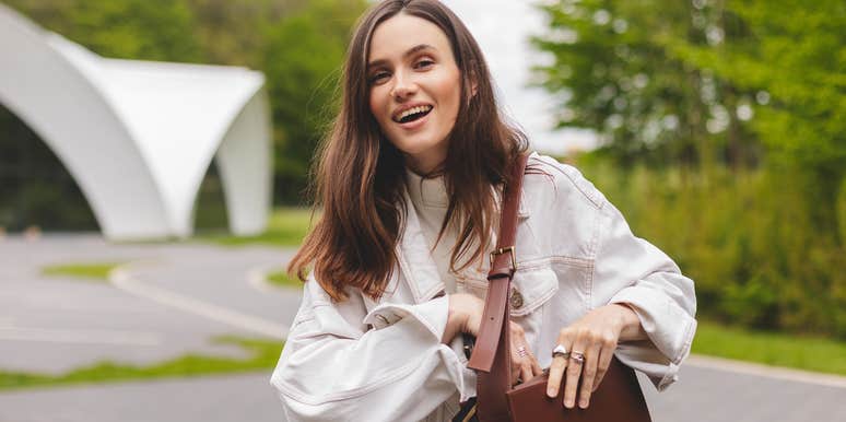 smiling frugal woman holding a purse