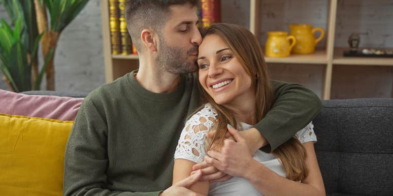 husband showing love to his wife kissing her head