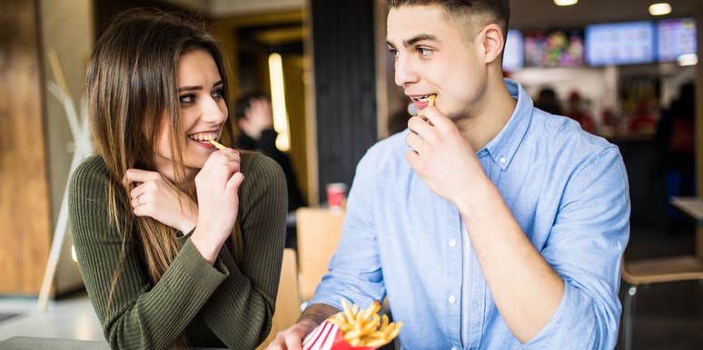 couple sharing fries on a date