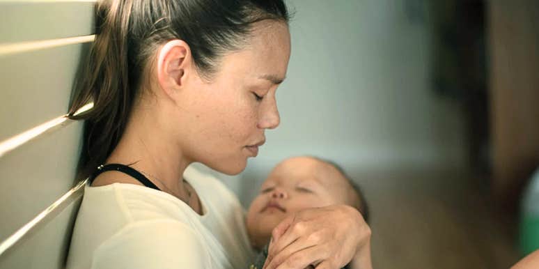 Heroic mom handles her sadness when things go wrong while cradling baby