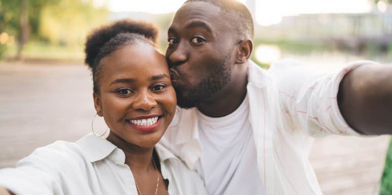 man kissing womans head madly in love with her