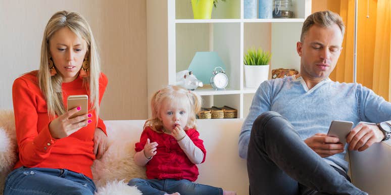 parents looking at their phones ignoring their child