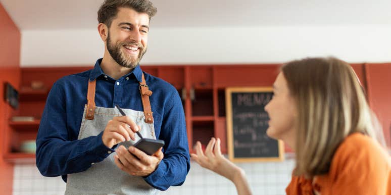 friendly waiter giving great service to customer