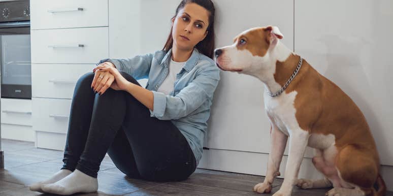 woman upset looking at dog