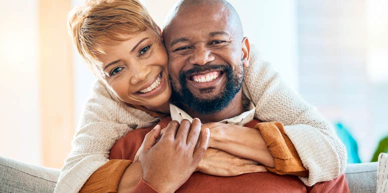 successful happy couple smiling together