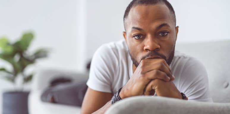 sad man lounging on his couch neglecting his self-care