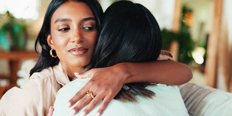 woman hugging friend secretly jealous of her
