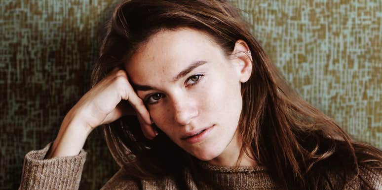 Thoughtful young woman indoors, embodying the deep emotion and soul sensitivity of a highly sensitive person.