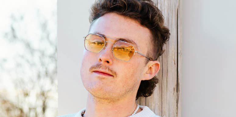 Confident man wearing sunglasses, representing types of guys who stay single due to unhealed childhood wounds