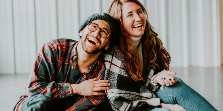 Playful couple laughing together, illustrating ways the most romantic couples keep their marriage full of sparks