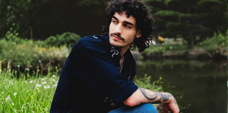 Man sitting contemplatively by a calm lake, illustrating the need for a personal space to process tears and emotions over the years
