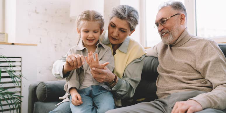 grandparents playing with granddaughter