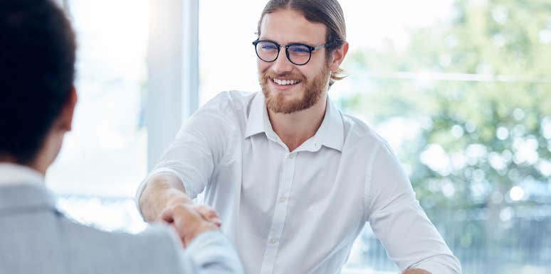 man shaking employers hand during job interview