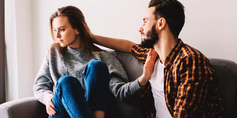 Dissatisfied woman pushing away her boyfriend showing the dynamic of chasing and pulling away and the shifts that change everything.