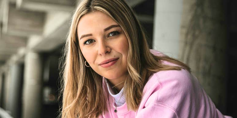 Confident woman standing with strong posture, representing the key obstacles people overcome to become more effective and transform their lives.