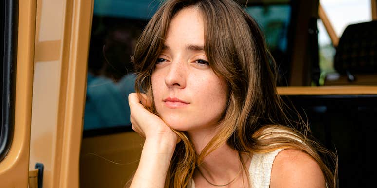 Carefree person sitting in the back of a car, lost in thought as sudden mental clarity breaks through—capturing the art of clear thinking and habits that erase brain fog instantly