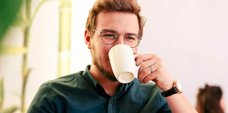 Confident, well-dressed man with a coffee cup and large watch, symbolizing the disciplined personalities that clash with procrastinators