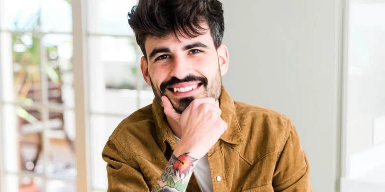 Person making warm eye contact with a subtle smile, embodying the art of likability and psychology-backed tricks that make people instantly warm up to you.