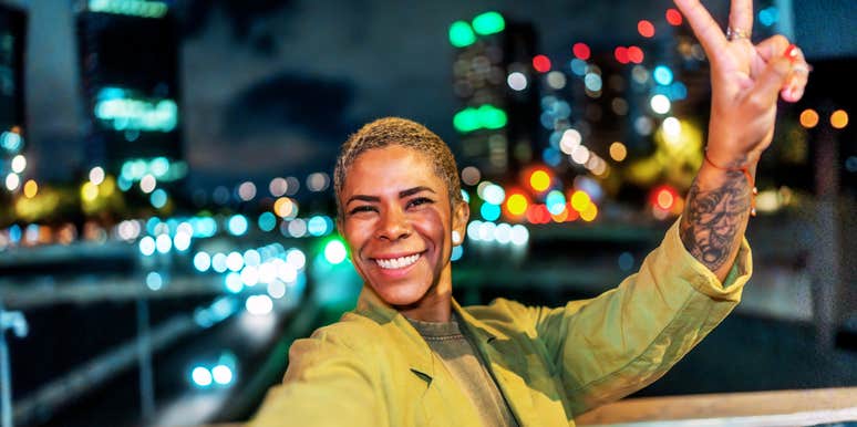 Happy, confident young Black woman in the city showing the art of a better life and habits of people who aren’t miserable