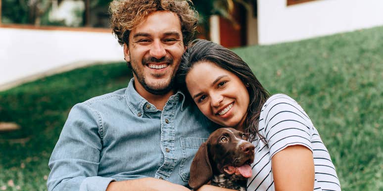 Couple smiling together despite being very different, symbolizing teamwork, understanding, and the emotional intelligence behind strong, healthy relationships.