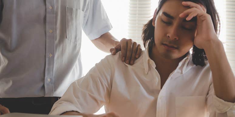 upset employee being comforted by boss