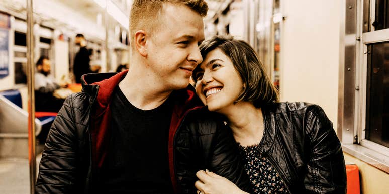 Man and woman sitting closely together on a train, illustrating habits that reveal whether two people are truly compatible, according to the CEO of eHarmony.