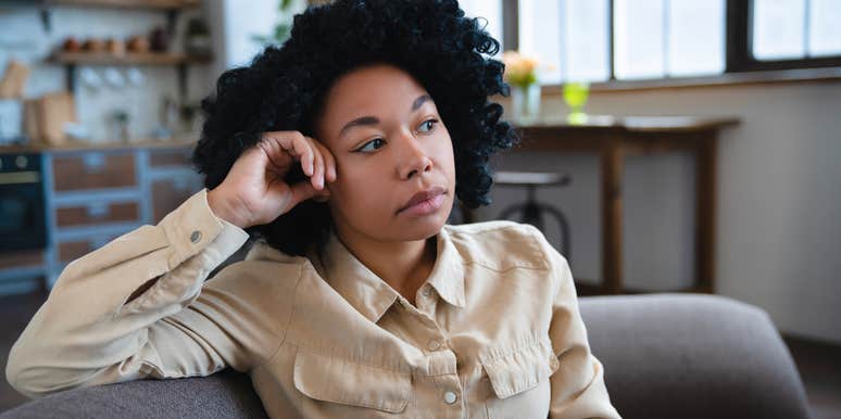 woman sitting on her couch feeling guilty for resting