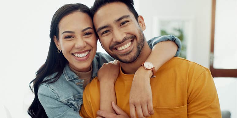 high-value man hugging his partner smiling