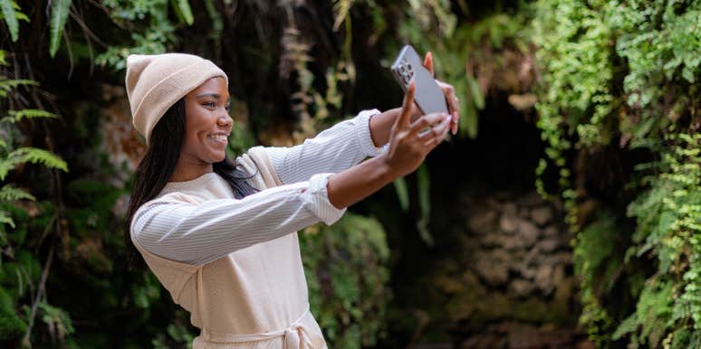 woman taking a selfie to change her profile picture