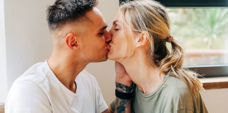 “Loving couple sharing a kiss showing how a wife prioritizes her husband and keeps him happy without neglecting their child.”