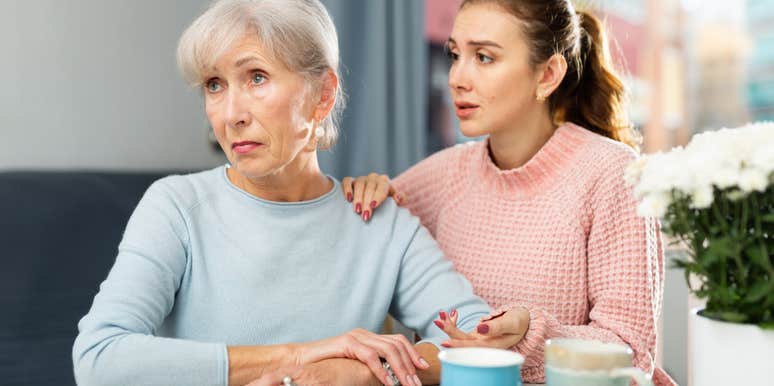 adult daughter concerned for mom sitting in kitchen