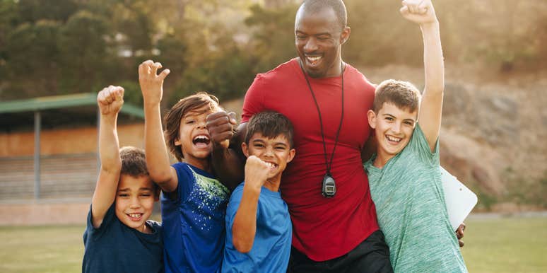 sports coach with group of kids