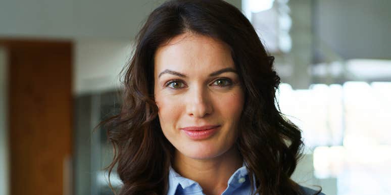 Confident professional woman smiling with purpose, embodying the energy of people who reinvent their careers later in life.