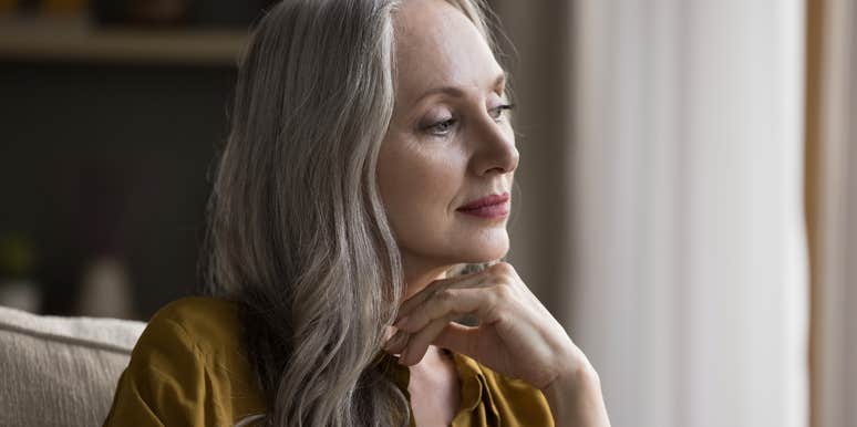 older woman sitting quietly in her home