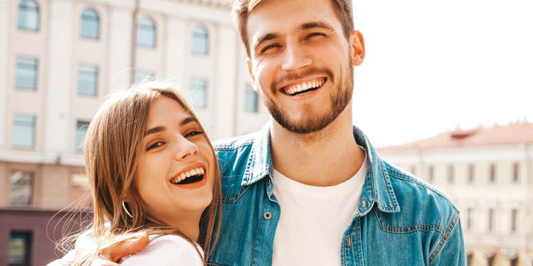 proud man hugging his partner smiling 