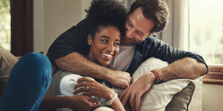 man valuing wife sitting on couch