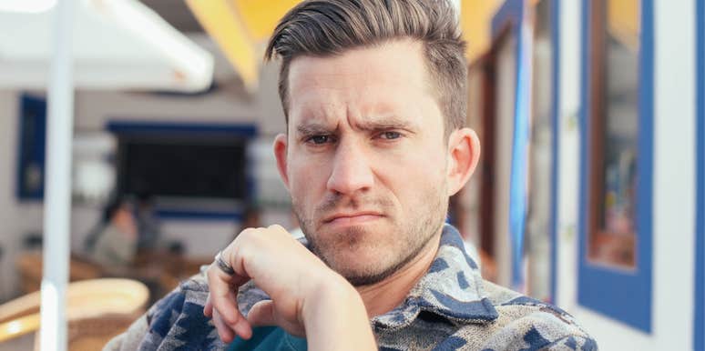 man looking unfriendly sitting outside