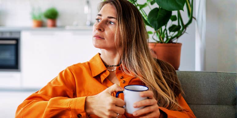 Thoughtful midlife woman looking out a window showing the quiet wishes wives have most at midlife according to a clinical psychologist