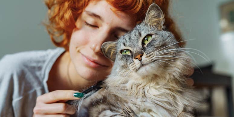 woman cuddling up to guardian spirit cat