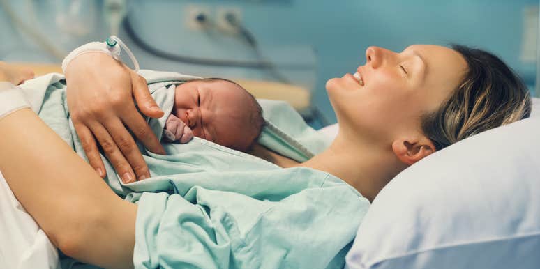 mom cuddling newborn baby in hospital