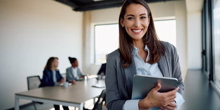 happy businesswoman in a meeting with colleagues