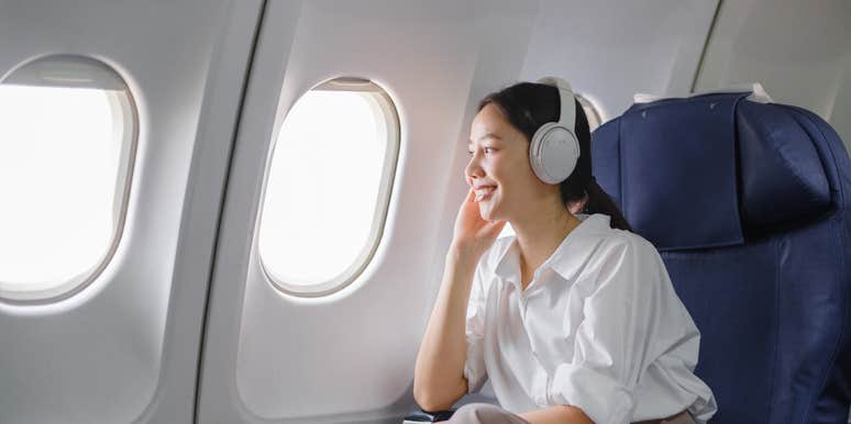 woman sitting in the window seat on a plane