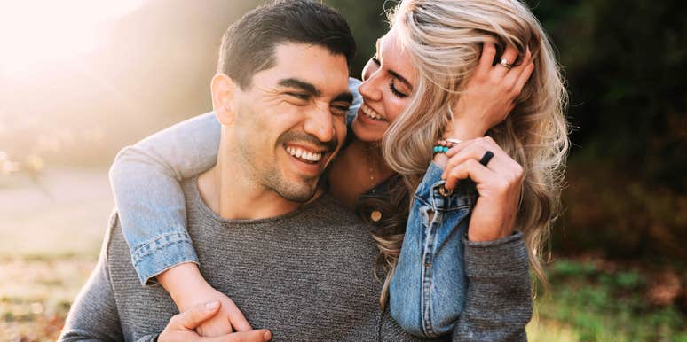 Long-married couple laughing playfully outdoors showing the meaningful milestones that make a marriage stronger by fifty.