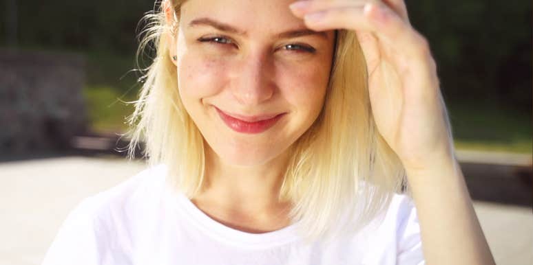 Smiling woman on a city street in casual clothes, meeting the camera with quiet confidence, capturing the moment you finally decide to make moves in your life.