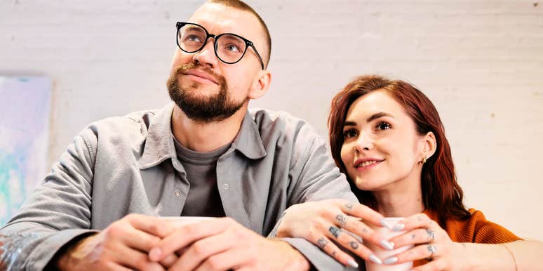 Man and woman sitting together at a table, appearing relaxed and comfortable in a quiet, unhurried moment.