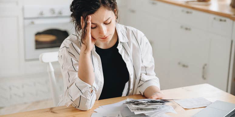 woman stressed about the price of buying a home on her income