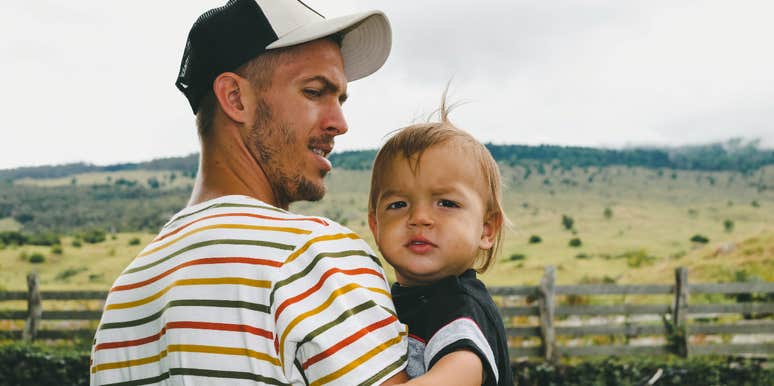 millennial dad holding son